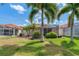 Well maintained backyard with green lawn and palm trees at 1260 Dartford Dr, Tarpon Springs, FL 34688