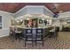 An angled, fully stocked bar features marble counters and pendant lighting at 1260 Dartford Dr, Tarpon Springs, FL 34688