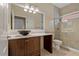 Bathroom featuring granite counters, a sleek black sink, and a glass-enclosed tiled shower with tile accents at 1260 Dartford Dr, Tarpon Springs, FL 34688