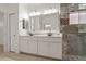 Elegant bathroom with double vanities, granite countertops, and a frameless shower at 1260 Dartford Dr, Tarpon Springs, FL 34688