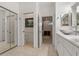 Bright bathroom with dual sinks and marble counters leads to commode and bedroom at 1260 Dartford Dr, Tarpon Springs, FL 34688