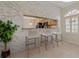 Breakfast bar with stone accent wall, and a view of the kitchen with wood cabinets and modern appliances at 1260 Dartford Dr, Tarpon Springs, FL 34688