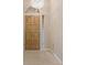 Welcoming entryway with light-toned floor tiles and featuring a wooden front door with decorative lighting at 1260 Dartford Dr, Tarpon Springs, FL 34688