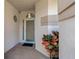 Inviting front entrance showcasing a tiled entryway, neutral paint colors, and a secure screen door at 1260 Dartford Dr, Tarpon Springs, FL 34688