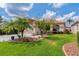 Charming front yard featuring lush green grass, beautiful landscaping, and a well-maintained exterior at 1260 Dartford Dr, Tarpon Springs, FL 34688