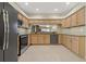 Spacious kitchen with stainless steel appliances, light wood cabinets, and granite countertops at 1260 Dartford Dr, Tarpon Springs, FL 34688