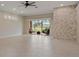 Bright living room with tile flooring, recessed lighting, sliding glass doors, and a stone accent wall at 1260 Dartford Dr, Tarpon Springs, FL 34688
