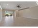 Spacious living room featuring tile floors, recessed lighting, stone accent wall, and sliding glass doors at 1260 Dartford Dr, Tarpon Springs, FL 34688