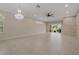 Spacious living area with tile flooring and stone accent wall, complemented by recessed lighting and natural light at 1260 Dartford Dr, Tarpon Springs, FL 34688