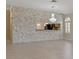 Spacious open-concept living room with stone accent wall and views into the kitchen at 1260 Dartford Dr, Tarpon Springs, FL 34688