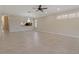 Bright, spacious living room with tile flooring, ceiling fan and natural light at 1260 Dartford Dr, Tarpon Springs, FL 34688