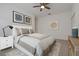 Comfortable main bedroom showcasing neutral decor, tiled floors, and natural light from a side table lamp at 1260 Dartford Dr, Tarpon Springs, FL 34688