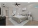 Bright main bedroom featuring a ceiling fan, neutral decor, and access to the lanai at 1260 Dartford Dr, Tarpon Springs, FL 34688
