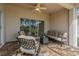 Covered outdoor patio boasting comfortable seating, patterned tile floor and a ceiling fan for relaxing at 1260 Dartford Dr, Tarpon Springs, FL 34688