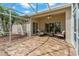 Screened patio with patterned tile flooring, ceiling fan and comfortable seating for outdoor enjoyment at 1260 Dartford Dr, Tarpon Springs, FL 34688