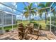 Outdoor patio with table and chairs overlooking golf course at 1260 Dartford Dr, Tarpon Springs, FL 34688