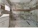 Luxury bathroom with walk-in shower, stylish tile work, and glass enclosure at 1260 Dartford Dr, Tarpon Springs, FL 34688