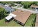 Birds-eye view of a home with a brown roof, a screened patio, and green grass at 13111 Sheridan Dr, Hudson, FL 34667