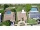 This aerial view shows a backyard with a pool and the home's driveway with parking at 13111 Sheridan Dr, Hudson, FL 34667