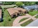 Aerial view of the home showcasing a large driveway and manicured landscaping at 13111 Sheridan Dr, Hudson, FL 34667