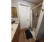 Bathroom featuring wood look floors, wood cabinets, and a shower stall at 13111 Sheridan Dr, Hudson, FL 34667