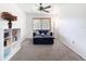 Cozy bedroom featuring neutral carpet, a ceiling fan, and a window with blinds at 13111 Sheridan Dr, Hudson, FL 34667
