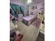 Bedroom with lavender walls, hardwood floors, curtained windows and a storage bed at 13111 Sheridan Dr, Hudson, FL 34667