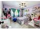 bedroom with purple walls, playful decor, a large window, and bed creating a fun and inviting space at 13111 Sheridan Dr, Hudson, FL 34667