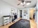 Bedroom with hardwood floors features a ceiling fan, desk, and closet creating a comfortable and functional space at 13111 Sheridan Dr, Hudson, FL 34667