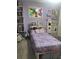 Bedroom with lavender walls, hardwood floors, storage bed and a book shelf at 13111 Sheridan Dr, Hudson, FL 34667