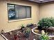 Exterior shot showcasing a courtyard with potted plants and a window at 13111 Sheridan Dr, Hudson, FL 34667