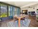 Bright dining area with natural light, modern rug, and stylish decor creates an inviting space for meals and gatherings at 13111 Sheridan Dr, Hudson, FL 34667