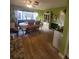 Charming dining room with a large window and rustic wooden dining set at 13111 Sheridan Dr, Hudson, FL 34667