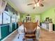 Bright dining room featuring wood floors, vintage furniture, and ample natural light at 13111 Sheridan Dr, Hudson, FL 34667