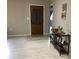 Welcoming entryway showcasing light tile floors and decorative console table, setting a warm tone for guests at 13111 Sheridan Dr, Hudson, FL 34667