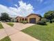 Charming home with manicured lawn, a spacious driveway and a two-car garage at 13111 Sheridan Dr, Hudson, FL 34667
