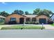 Charming single story home featuring an arched entryway and an attached garage at 13111 Sheridan Dr, Hudson, FL 34667