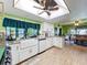 Bright kitchen featuring modern appliances, granite countertops, and a stylish farmhouse sink at 13111 Sheridan Dr, Hudson, FL 34667
