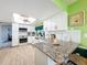 Bright and modern kitchen featuring granite countertops, subway tile backsplash, and updated appliances at 13111 Sheridan Dr, Hudson, FL 34667