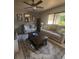 Well-lit living room featuring comfortable seating, a ceiling fan, and decorative accents at 13111 Sheridan Dr, Hudson, FL 34667