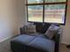 Living room with oversized window providing natural light and a backyard view at 13111 Sheridan Dr, Hudson, FL 34667