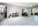Spacious living area with light gray floors, and an adjacent bathroom at 13111 Sheridan Dr, Hudson, FL 34667