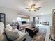 Inviting living room with a ceiling fan, area rug, and comfortable seating at 13111 Sheridan Dr, Hudson, FL 34667