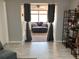 Living room with curtains, window, comfortable seating, offering views to another room at 13111 Sheridan Dr, Hudson, FL 34667