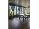 Charming sunroom with a dining table, surrounded by windows offering pleasant outdoor views, perfect for enjoying meals at 13111 Sheridan Dr, Hudson, FL 34667