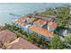 Aerial view showcasing the community's architecture with red-tiled roofs and lush greenery near the bay at 1340 Bayshore Blvd # 411, Dunedin, FL 34698