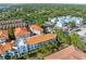 A scenic aerial view of waterfront condos featuring orange tile roofs and lush greenery at 1340 Bayshore Blvd # 411, Dunedin, FL 34698