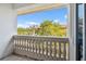 Balcony view with white railings providing outdoor space with a view of nearby trees and a building at 1340 Bayshore Blvd # 411, Dunedin, FL 34698