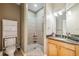 Bathroom features a toilet, vanity with granite countertops, and a tiled shower with glass door at 1340 Bayshore Blvd # 411, Dunedin, FL 34698