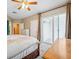 Bedroom showing a ceiling fan, large closet with sliding glass doors, and modern sliding doors at 1340 Bayshore Blvd # 411, Dunedin, FL 34698
